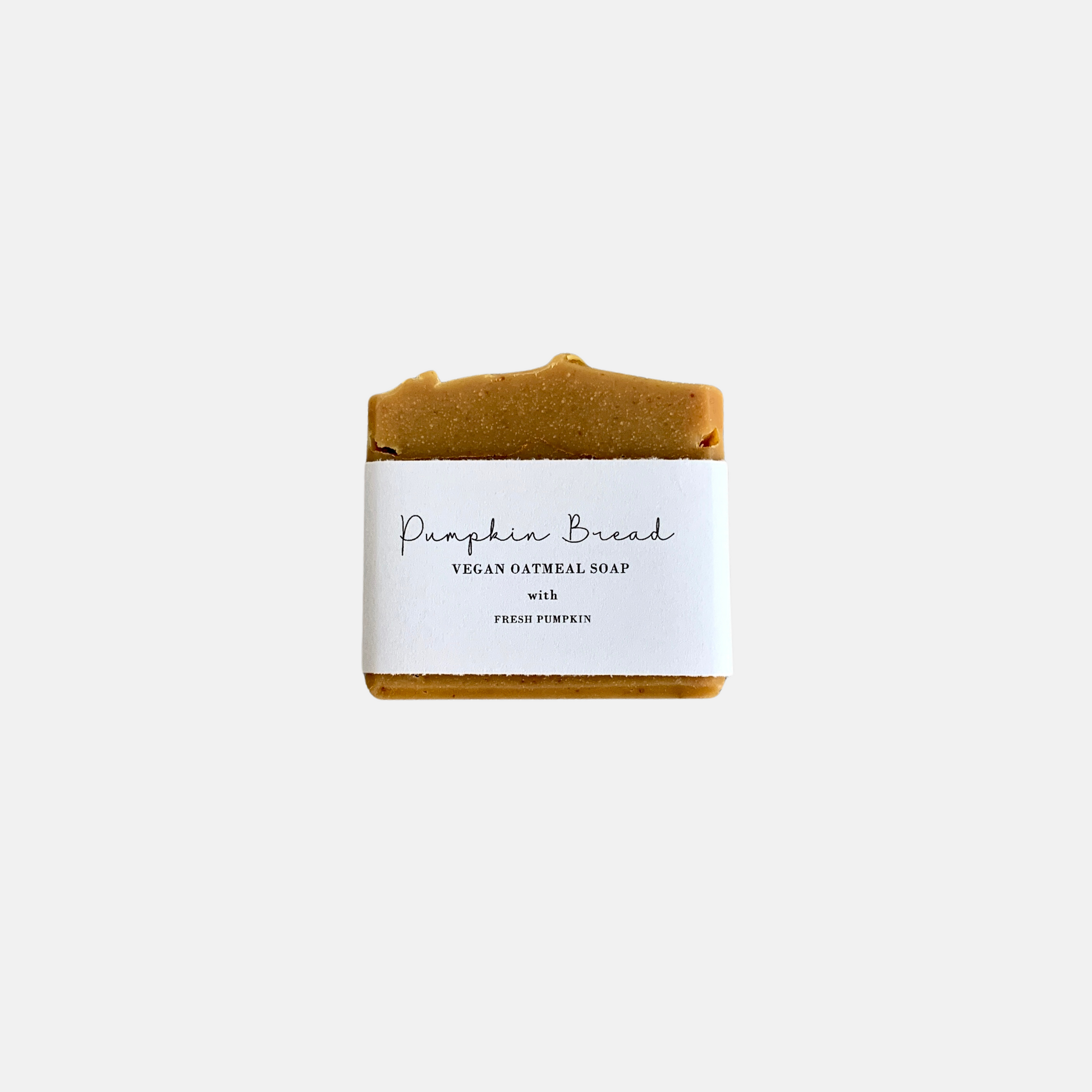 pumpkin vegan soap bar with a white label 